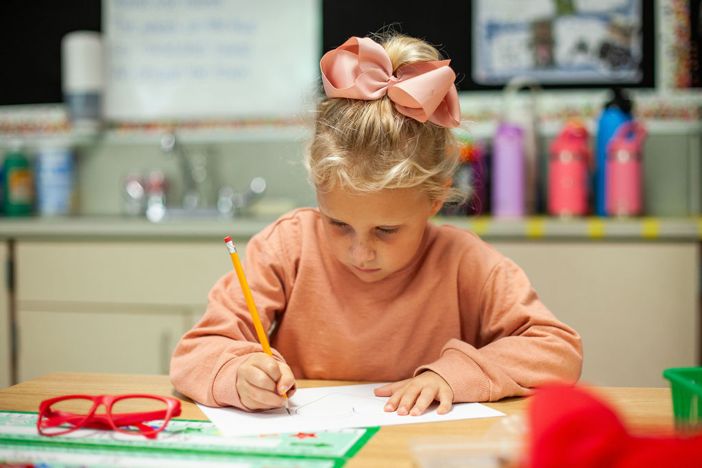 Elementary student working on an assignment at a desk