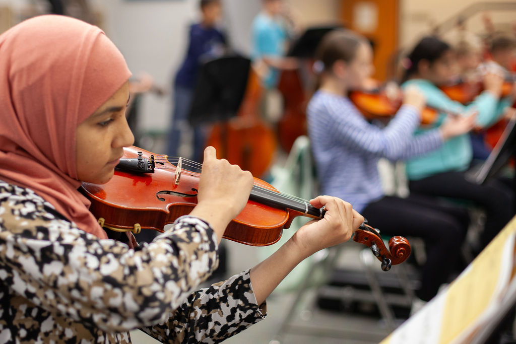 Student playing a violin