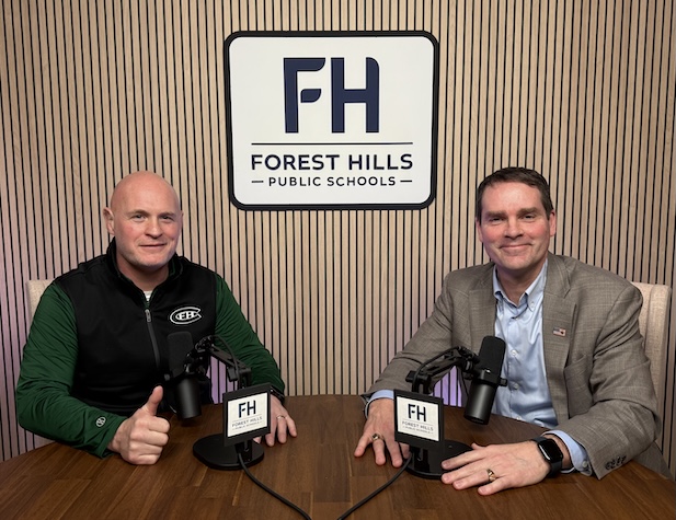 The superintendent and a male central staff member ready to record a podcast