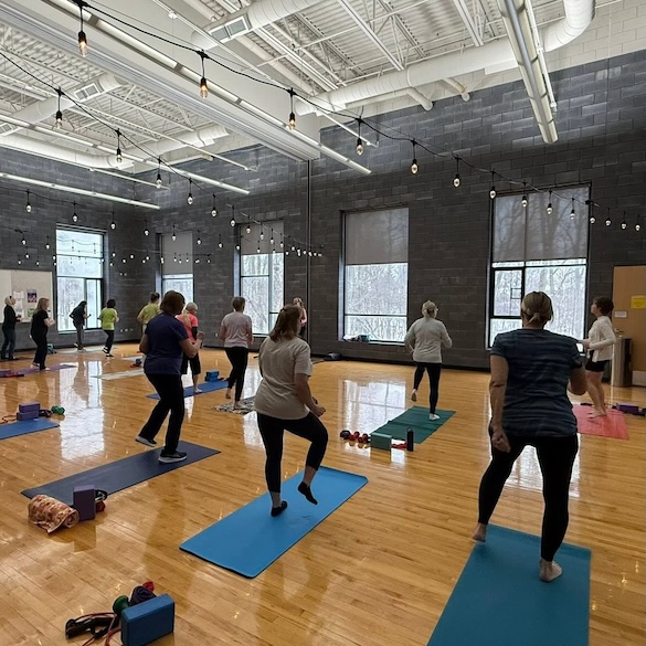 Community members doing exercise in an open space with an instructor
