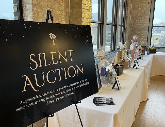 Silent auction poster with different products on the table