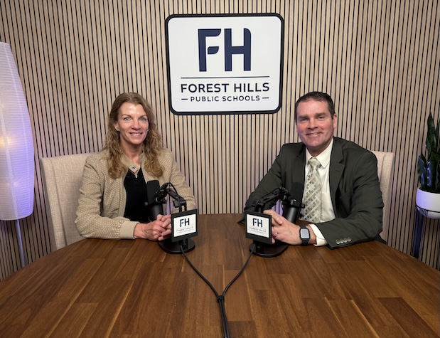 The superintendent and a female staff member ready to record a podcast