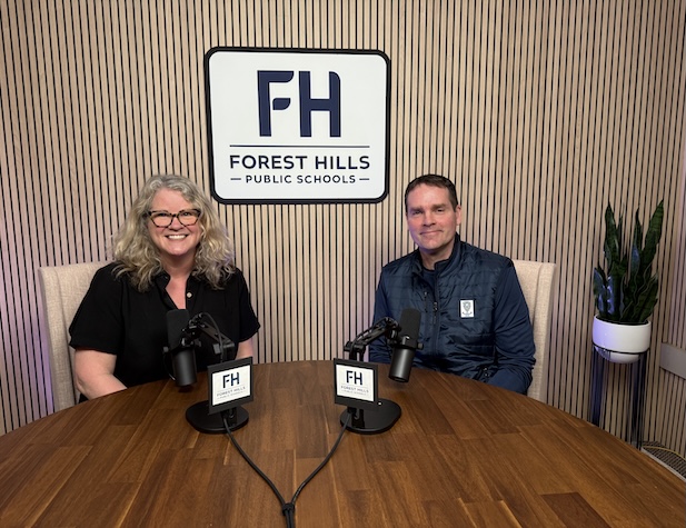 The superintendent and a female staff member ready to record a podcast