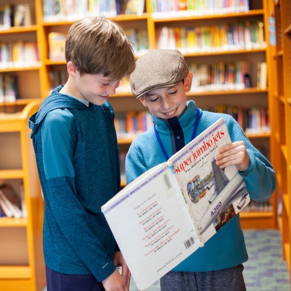 two students reading a book